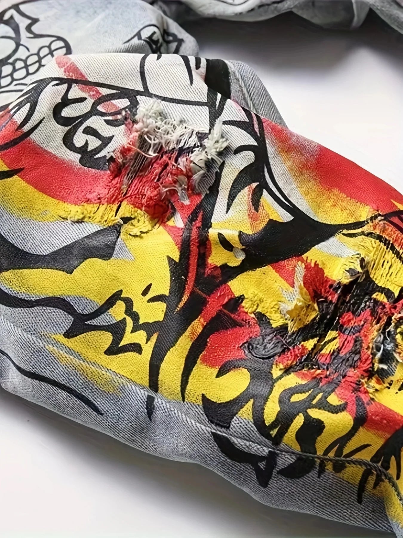 printed graffiti old washed and ripped jeans